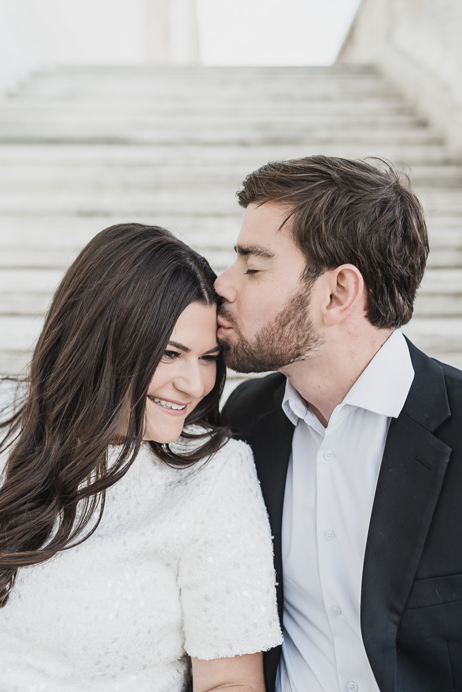A tender forhead kiss moment for this couple during their Detroit Institute of Arts downtown Detroit Engagement photos by Kari Dawson