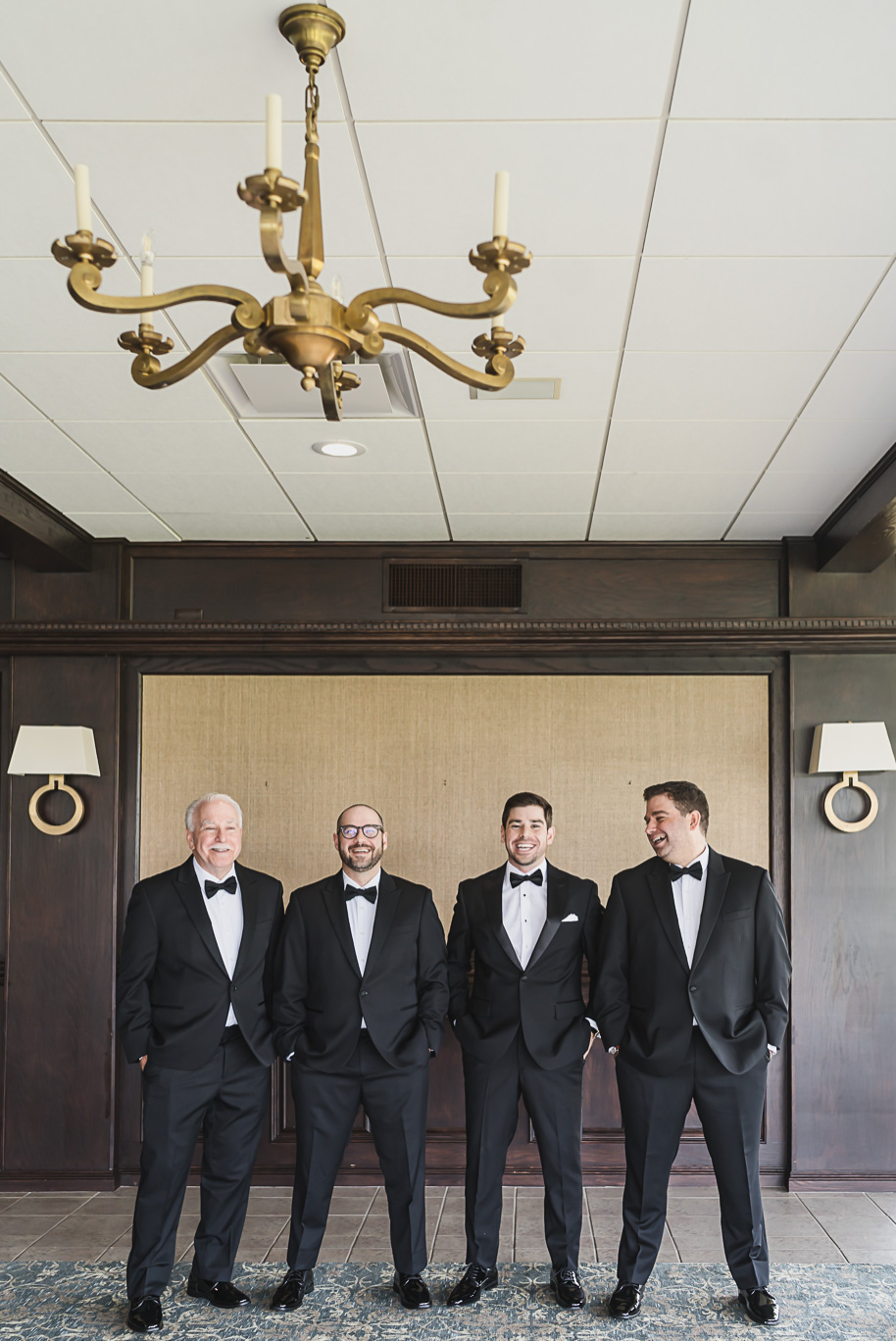 Groom with his groomsmen dressed in black tuxedos, photographed at Bay Pointe Golf Club before the Jewish wedding ceremony.