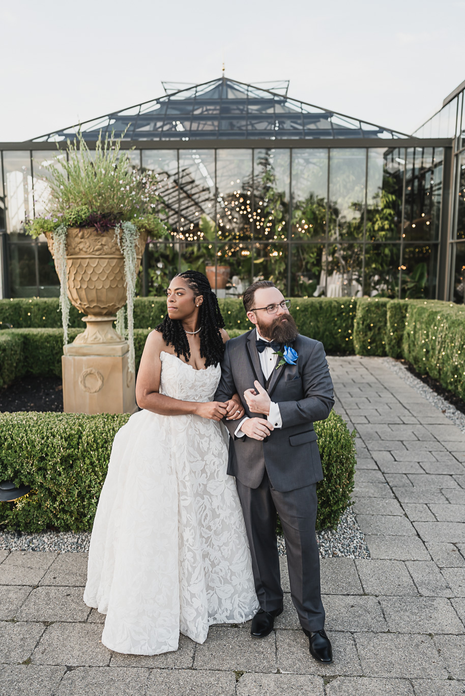 An elegant fall Planterra Conservatory wedding captured by Kari Dawson + Co in Bloomfield Hills, Michigan. This Euro-inspired greenhouse celebration featured lush floral design, golden candlelight, and heartfelt vows beneath the glass canopy. Perfect inspiration for couples dreaming of a romantic Michigan wedding surrounded by nature and timeless architecture.