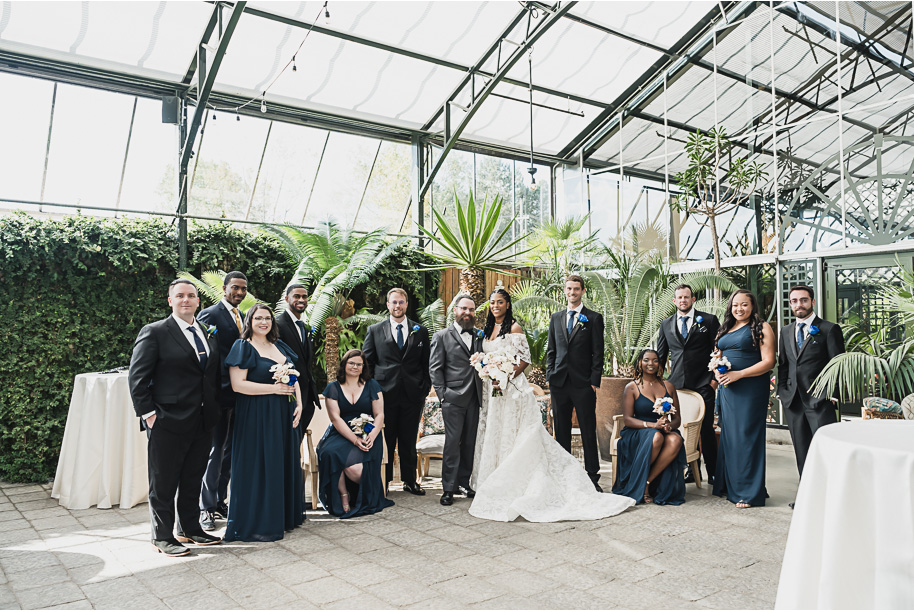 An elegant fall Planterra Conservatory wedding captured by Kari Dawson + Co in Bloomfield Hills, Michigan. This Euro-inspired greenhouse celebration featured lush floral design, golden candlelight, and heartfelt vows beneath the glass canopy. Perfect inspiration for couples dreaming of a romantic Michigan wedding surrounded by nature and timeless architecture.