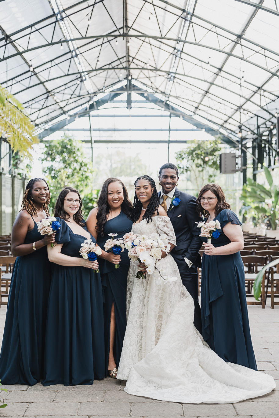 An elegant fall Planterra Conservatory wedding captured by Kari Dawson + Co in Bloomfield Hills, Michigan. This Euro-inspired greenhouse celebration featured lush floral design, golden candlelight, and heartfelt vows beneath the glass canopy. Perfect inspiration for couples dreaming of a romantic Michigan wedding surrounded by nature and timeless architecture.