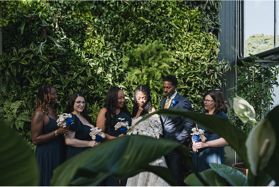 An elegant fall Planterra Conservatory wedding captured by Kari Dawson + Co in Bloomfield Hills, Michigan. This Euro-inspired greenhouse celebration featured lush floral design, golden candlelight, and heartfelt vows beneath the glass canopy. Perfect inspiration for couples dreaming of a romantic Michigan wedding surrounded by nature and timeless architecture.
