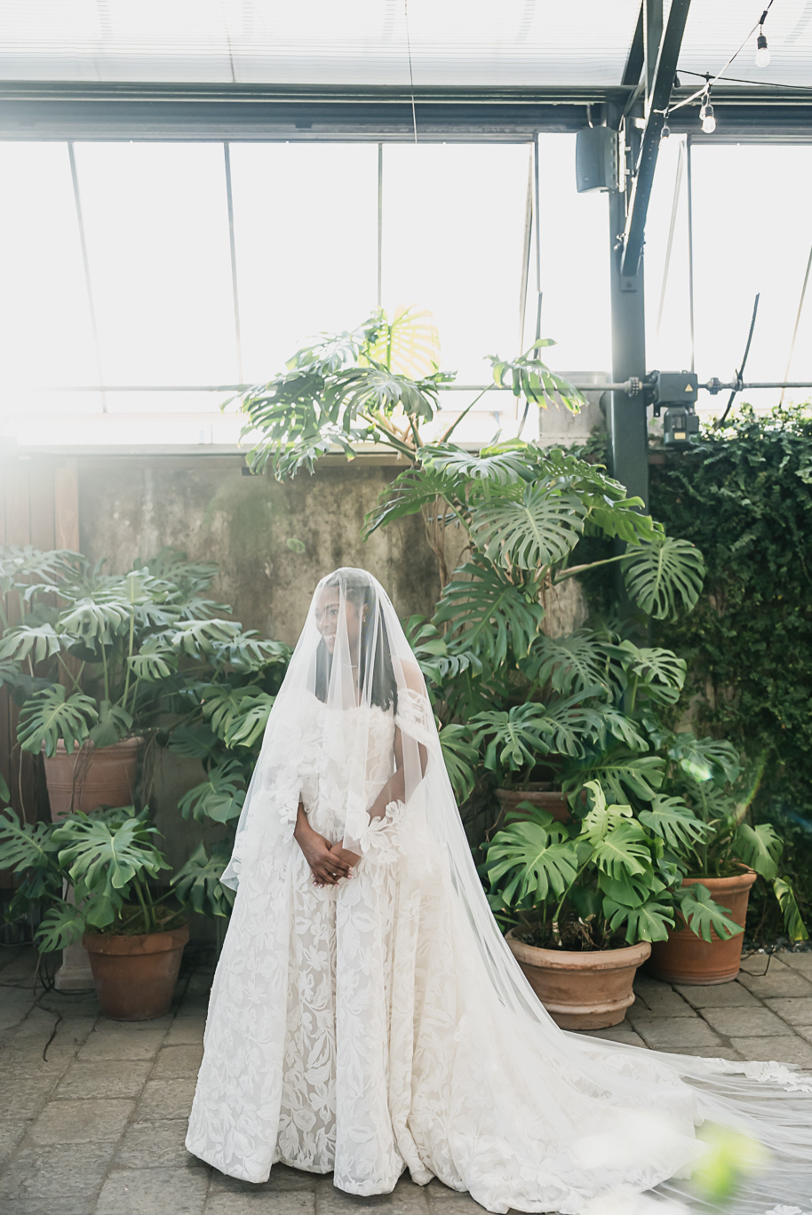 An elegant fall Planterra Conservatory wedding captured by Kari Dawson + Co in Bloomfield Hills, Michigan. This Euro-inspired greenhouse celebration featured lush floral design, golden candlelight, and heartfelt vows beneath the glass canopy. Perfect inspiration for couples dreaming of a romantic Michigan wedding surrounded by nature and timeless architecture.