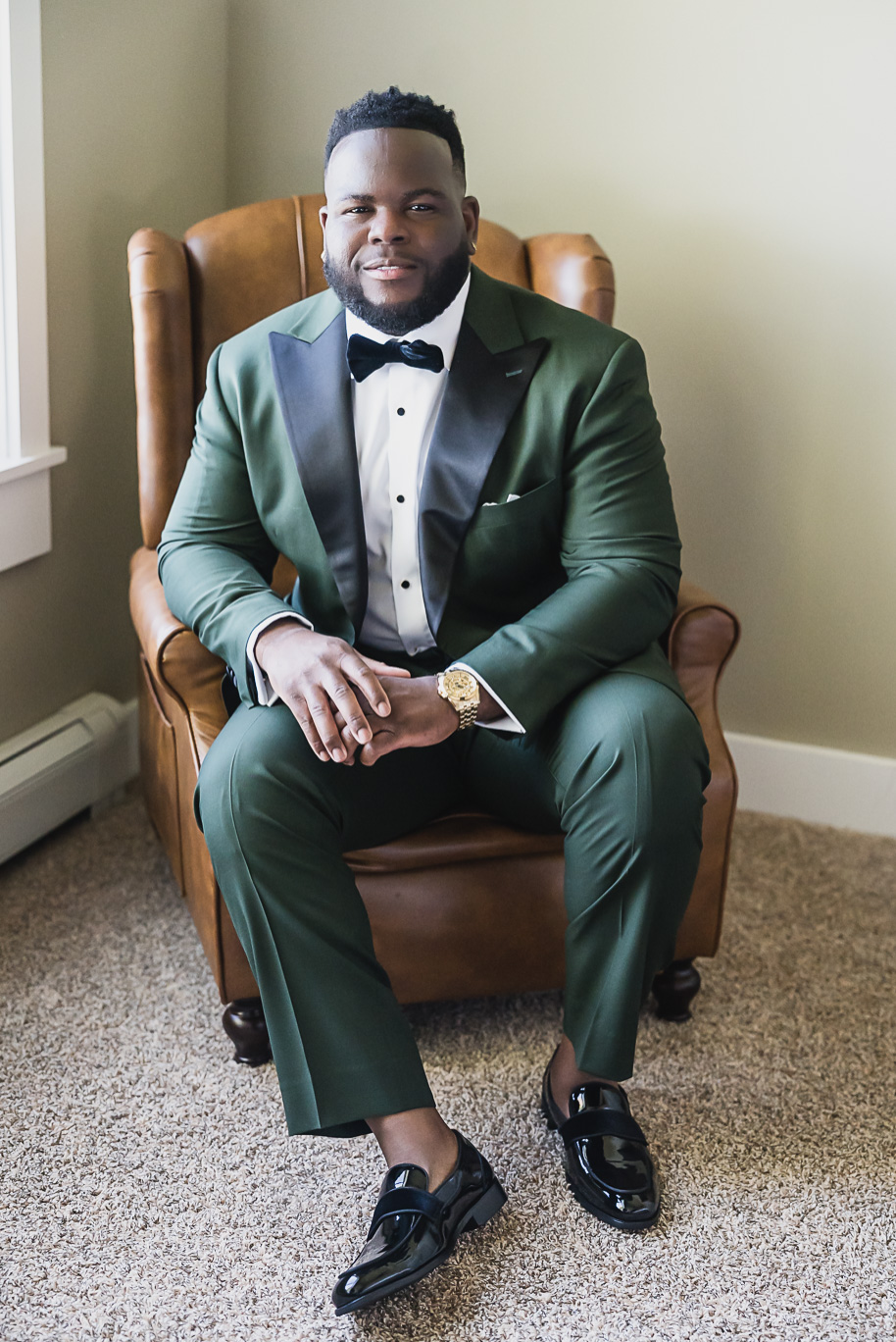 “Stylish groom wearing a custom emerald green tuxedo before his Castle Farms wedding in Northern Michigan. Captured by Kari Dawson + Co, this timeless editorial portrait highlights modern menswear inspiration for black tie weddings.