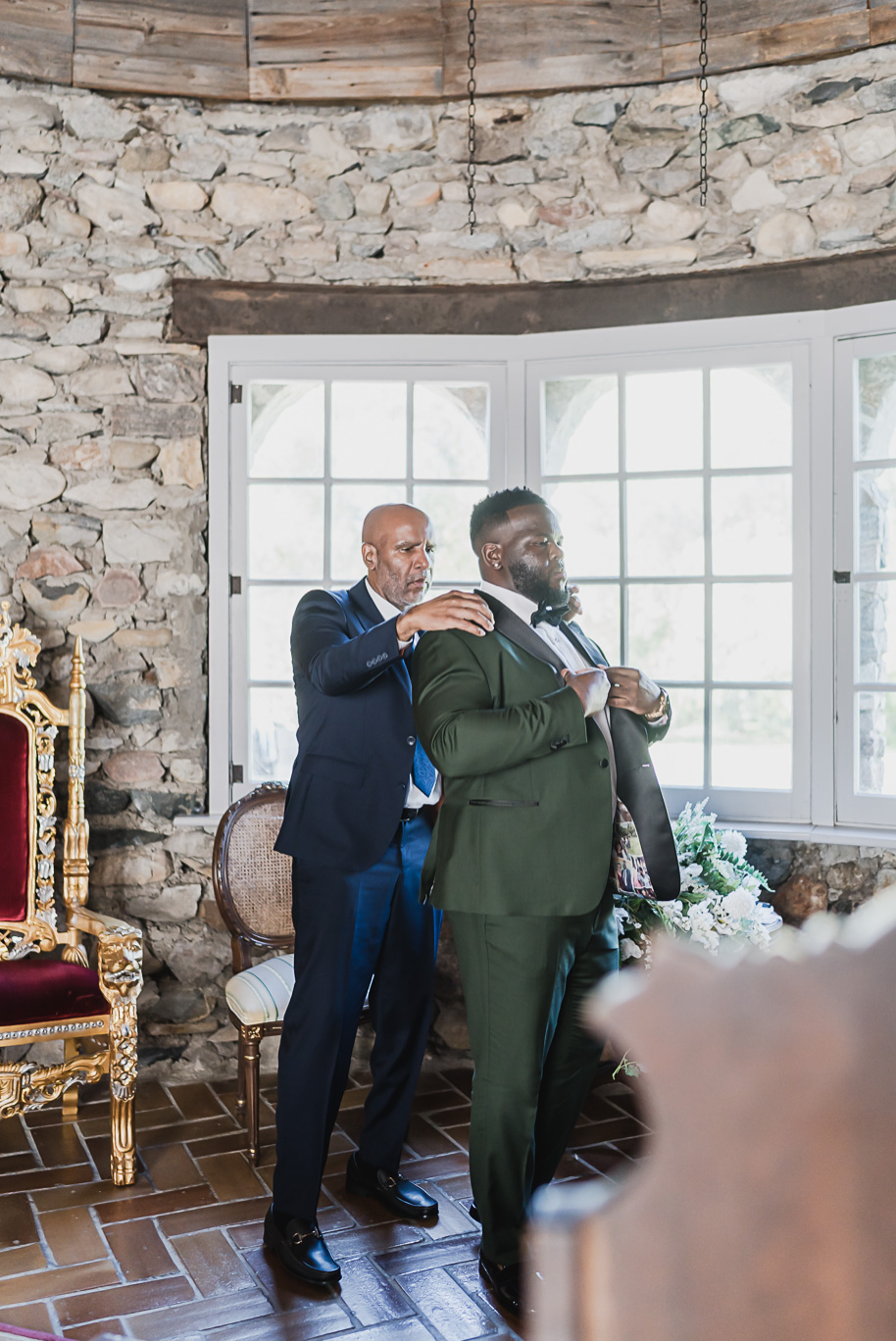 “Stylish groom wearing a custom emerald green tuxedo before his Castle Farms wedding in Northern Michigan. Captured by Kari Dawson + Co, this timeless editorial portrait highlights modern menswear inspiration for black tie weddings.
