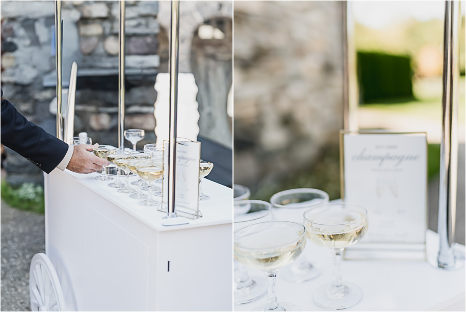 “Guests enjoy champagne from a mobile cart before the ceremony at Castle Farms in Charlevoix, Michigan. Editorial wedding photography by Kari Dawson + Co capturing elevated cocktail hour details and timeless guest style.