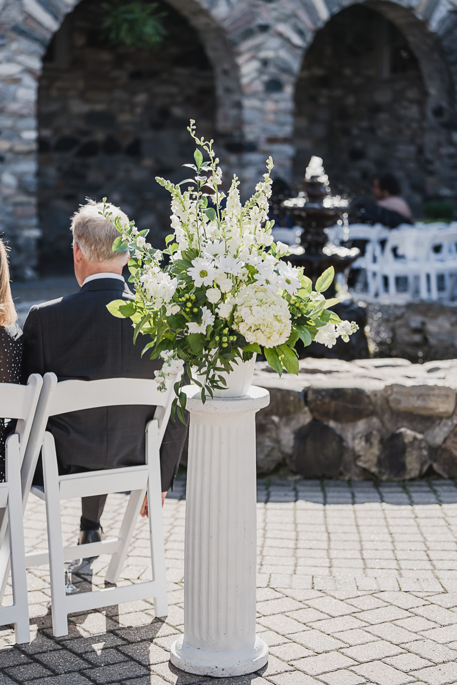 Floral pillars. An emerald and gold fall interracial Castle Farms wedding in Charlevoix Northern Michigan by top-rated Northern Michigan wedding photography team Kari Dawson + Co.