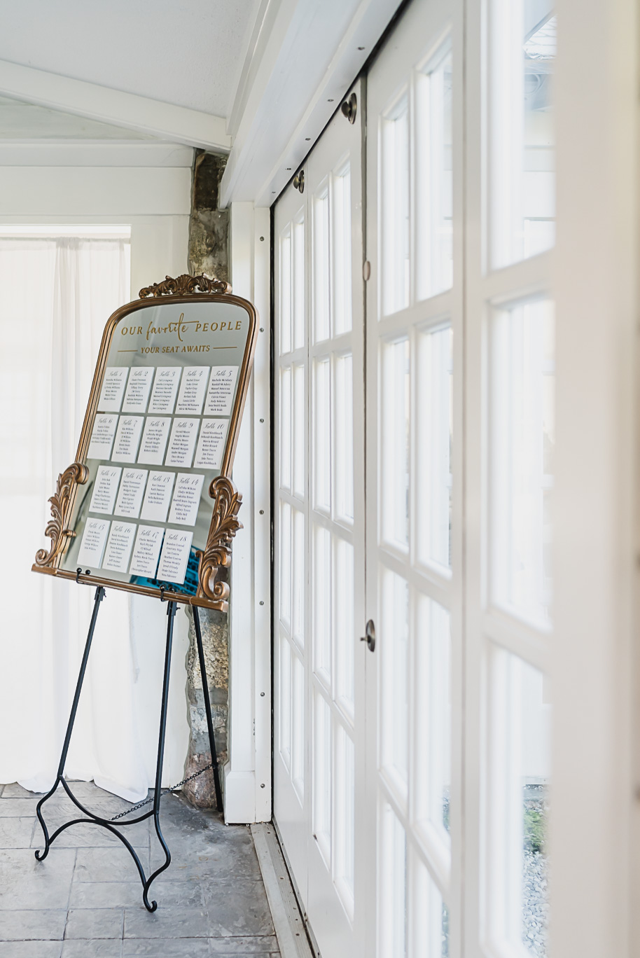 “Elegant gold mirror seating chart displayed at a Castle Farms wedding in Charlevoix, Northern Michigan. Captured by Kari Dawson + Co, this refined detail shot highlights timeless wedding design with modern calligraphy and luxurious decor.