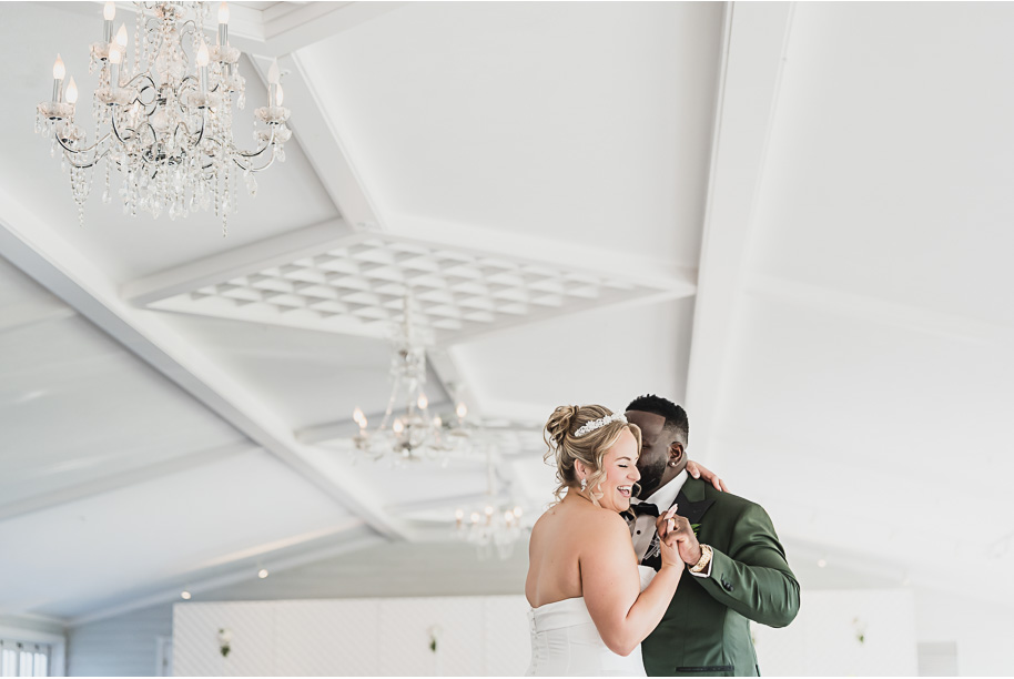 A bride and groom share thier first dance at their An emerald and gold fall interracial Castle Farms wedding in Charlevoix Northern Michigan by top-rated Northern Michigan wedding photography team Kari Dawson + Co.