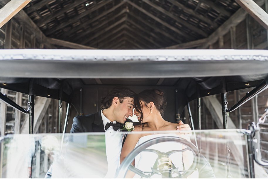 Bride and groom stand beside a black Model T at Greenfield Village for portraits, a nod to Detroit’s history.
