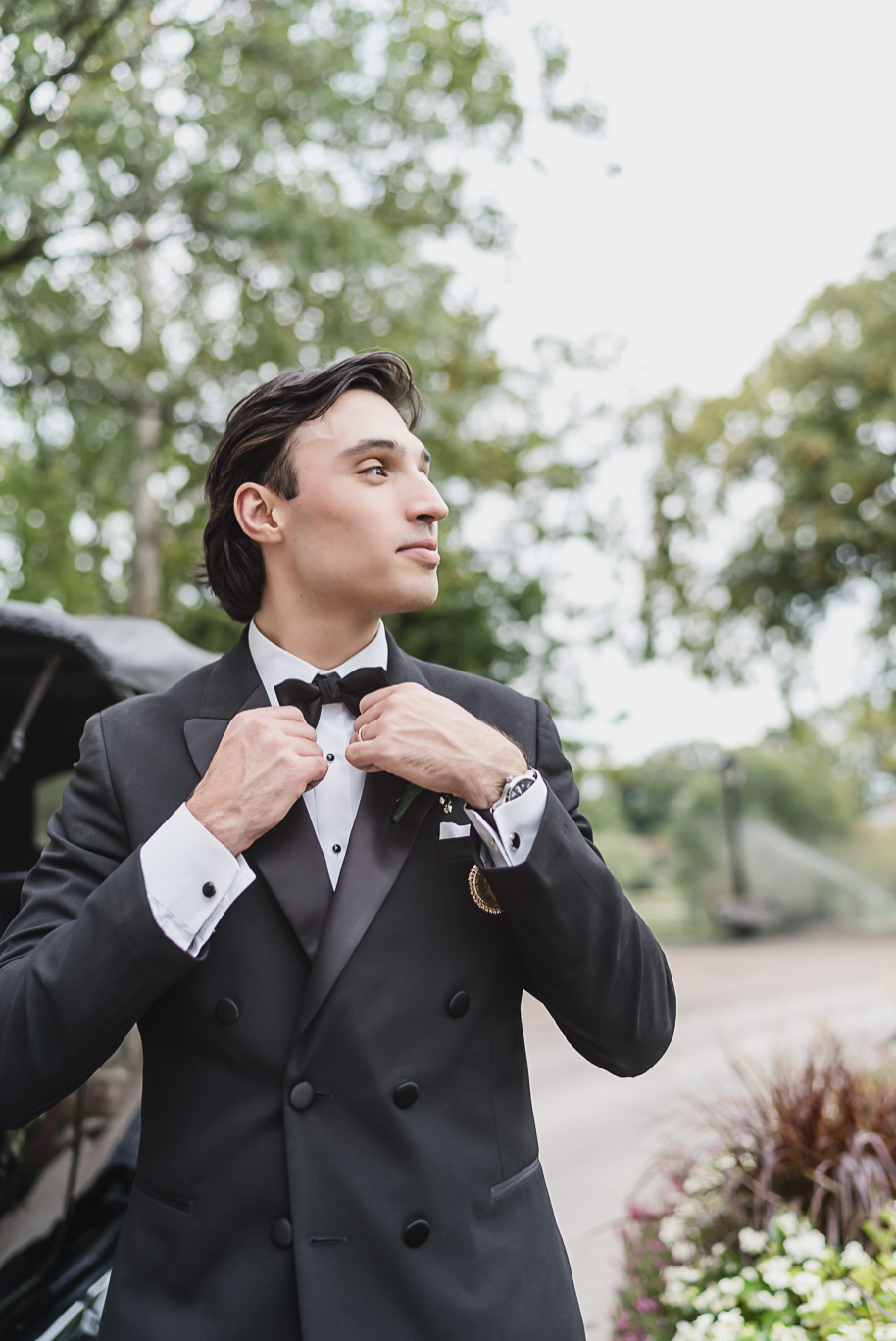 Bride and groom stand beside a black Model T at Greenfield Village for portraits, a nod to Detroit’s history.
