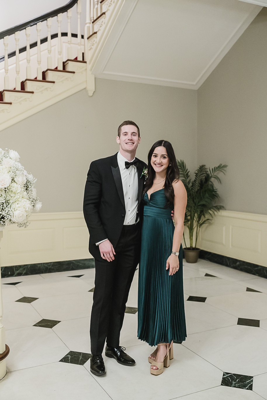 Classic Lovett Hall reception setup with chandeliers, round tables, and timeless white floral centerpieces.