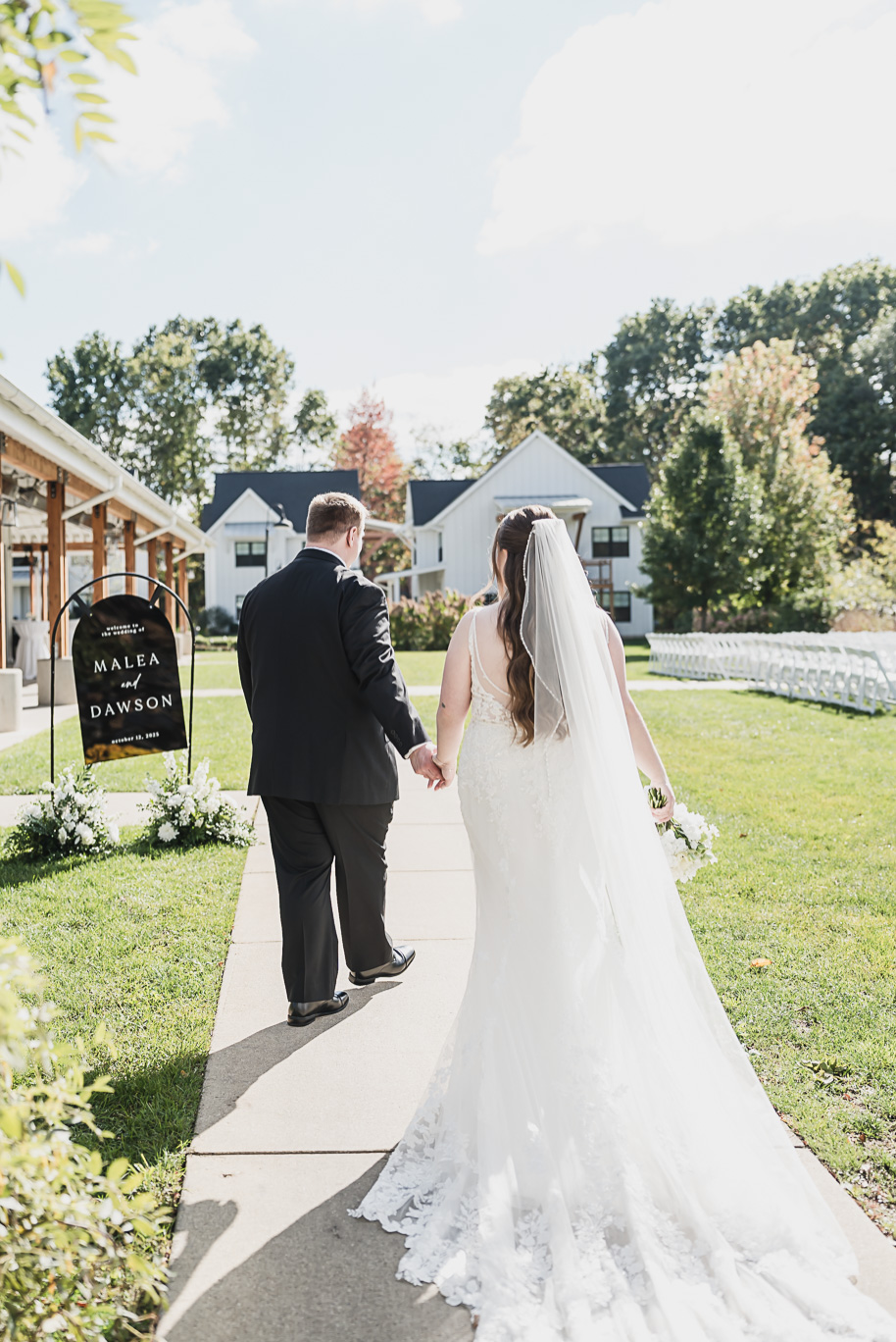 A fall Bay Pointe Woods wedding in Shelbyville, Michigan, featuring white and sage details, black-tie elegance, and heartfelt family legacy. Photographed by Kari Dawson + Co.
