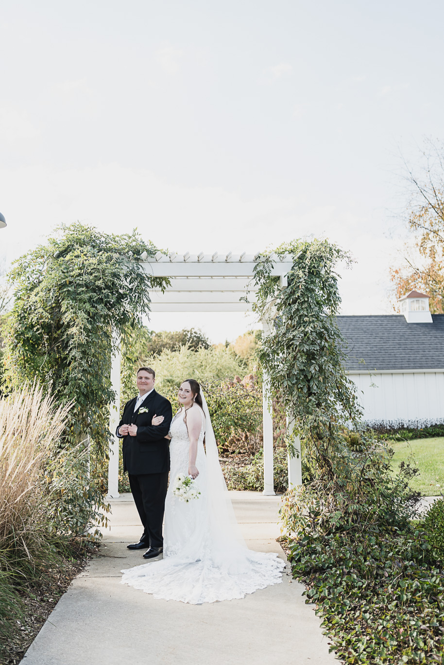 A fall Bay Pointe Woods wedding in Shelbyville, Michigan, featuring white and sage details, black-tie elegance, and heartfelt family legacy. Photographed by Kari Dawson + Co.
