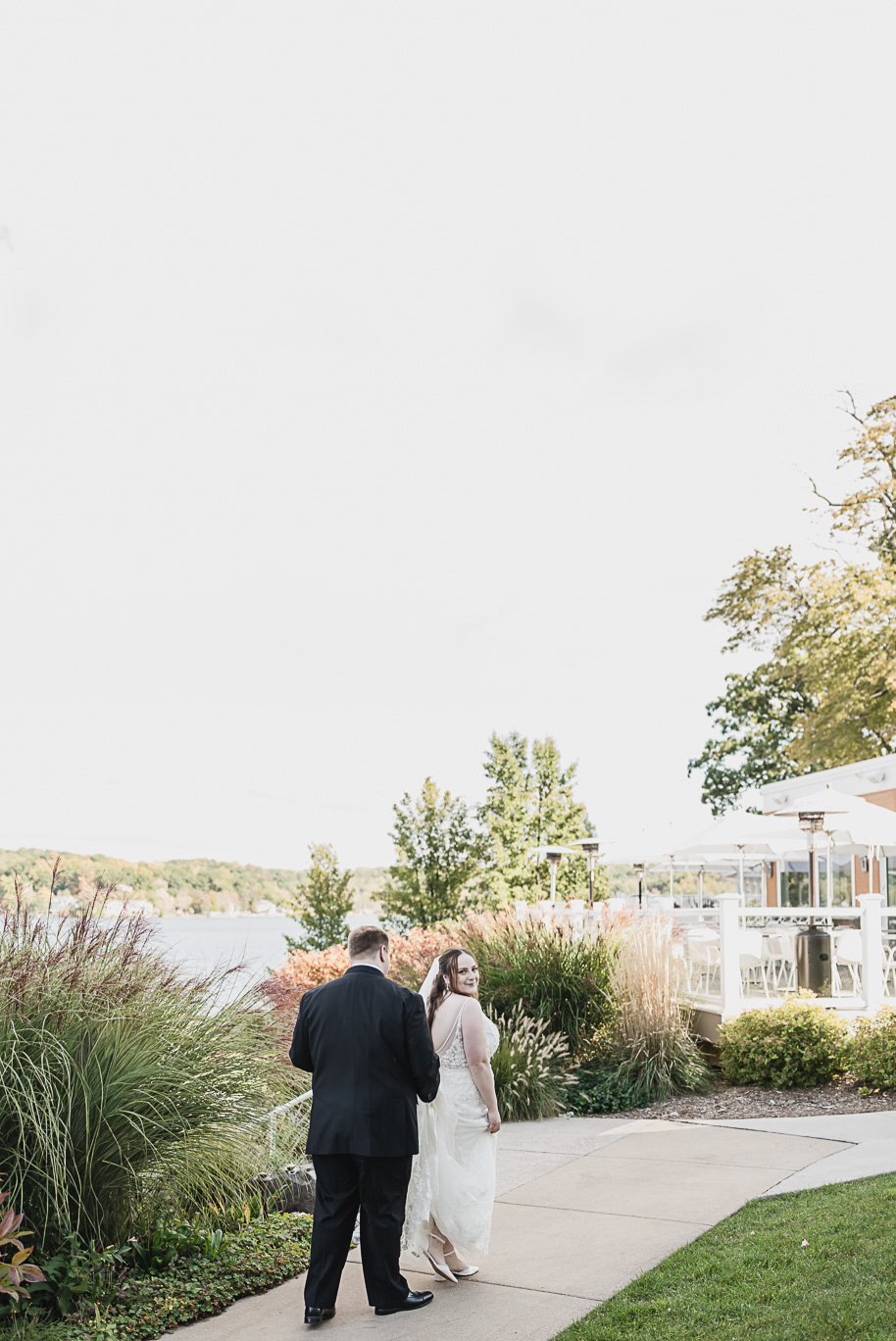 A warm fall Bay Pointe Woods wedding in Northern Michigan with sage and white details, emotional family legacy, and timeless design. Captured by Kari Dawson + Co.