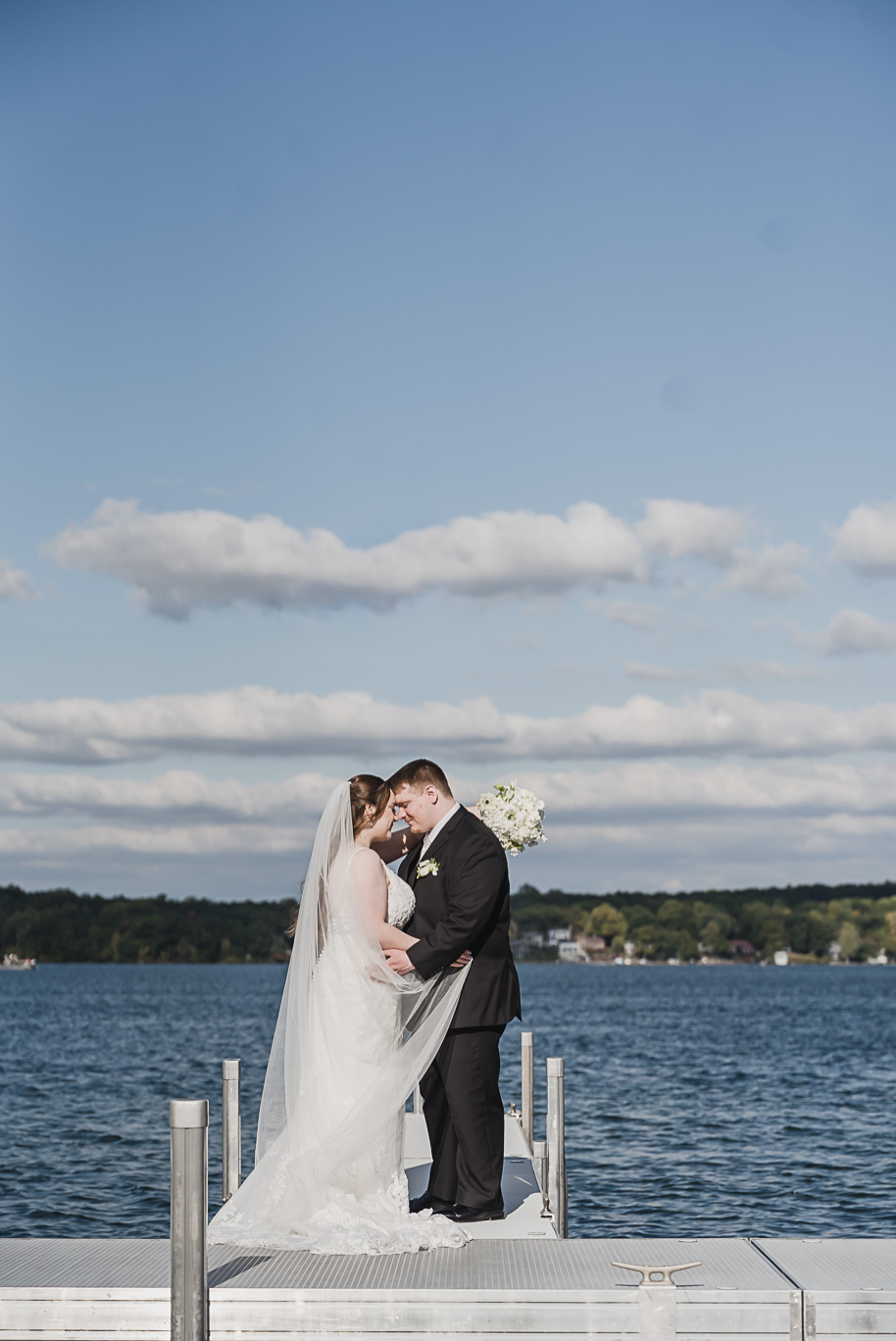 A warm fall Bay Pointe Woods wedding in Northern Michigan with sage and white details, emotional family legacy, and timeless design. Captured by Kari Dawson + Co.