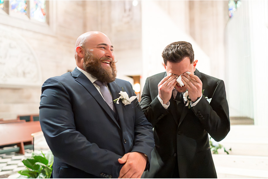 Groom in black classic tux having an emotional moment during ceremony at Cathedral of the Most Blessed Sacrament Detroit