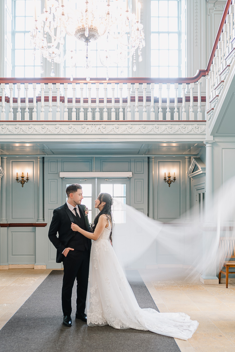 Bride and groom share an intimate moment in the iconic blue room at their wedding at the Henry Ford Museum.
